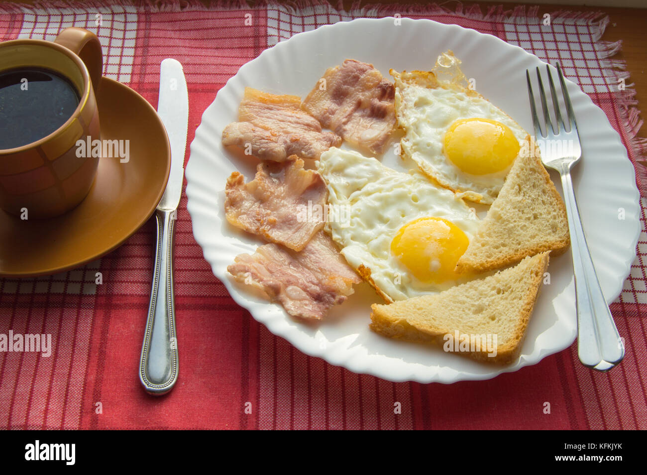 Delicious Breakfast - a Cup of coffee, a plate of fried eggs, bacon and ...