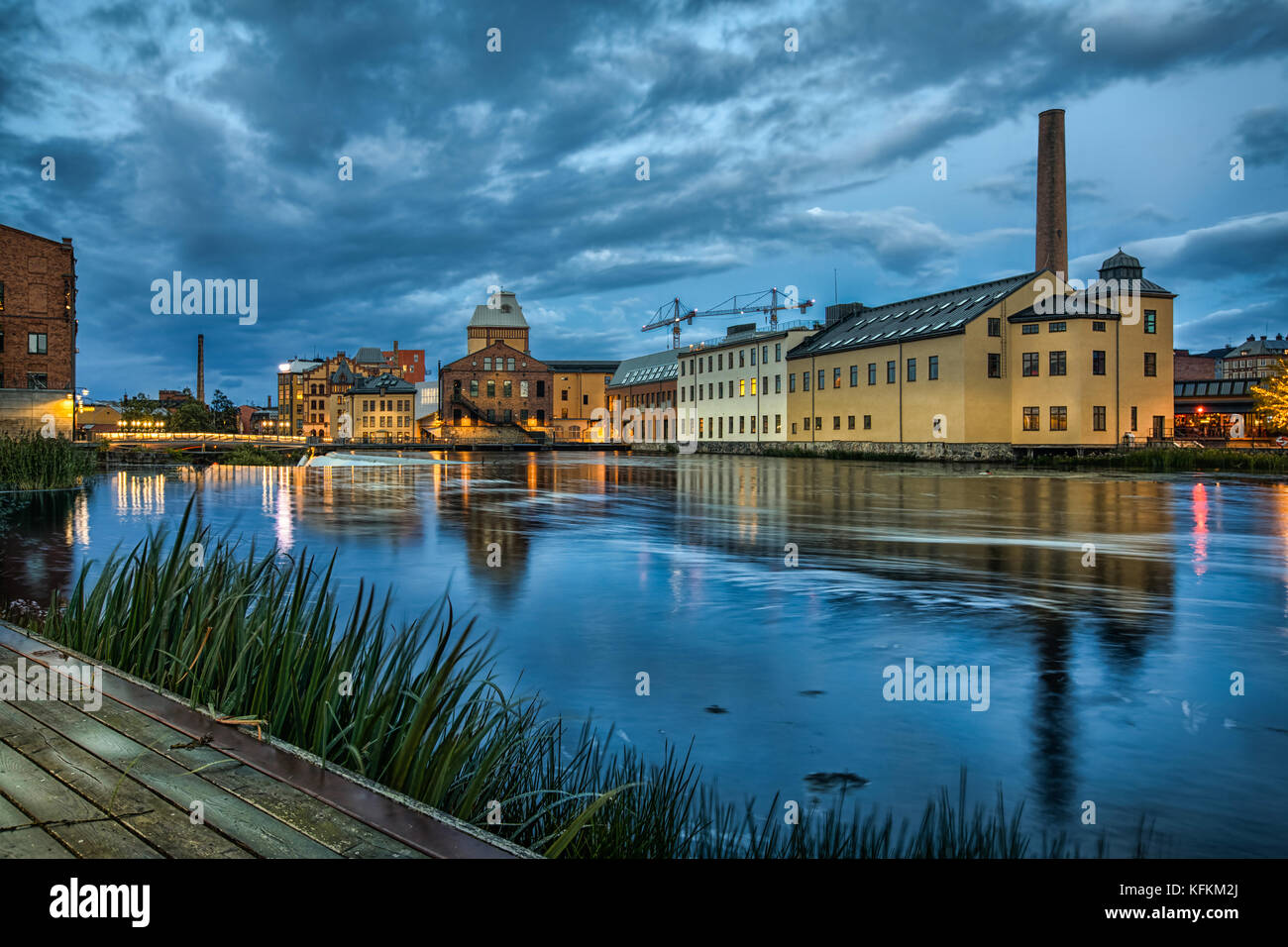 Historical textile industrial area and Motala river at dusk in Norrkoping, Sweden Stock Photo