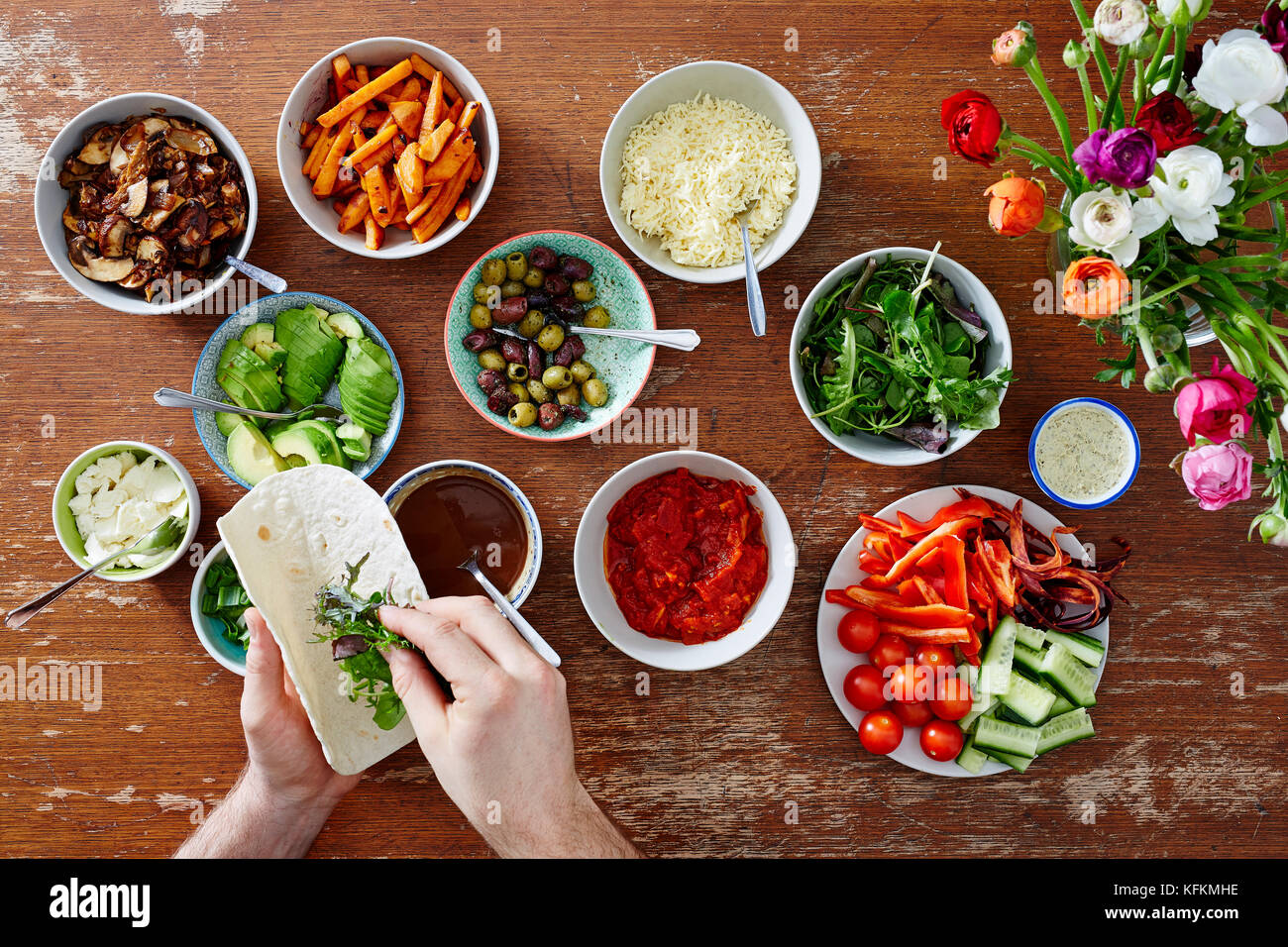 hand filling wrap with salad fresh organic foods Stock Photo
