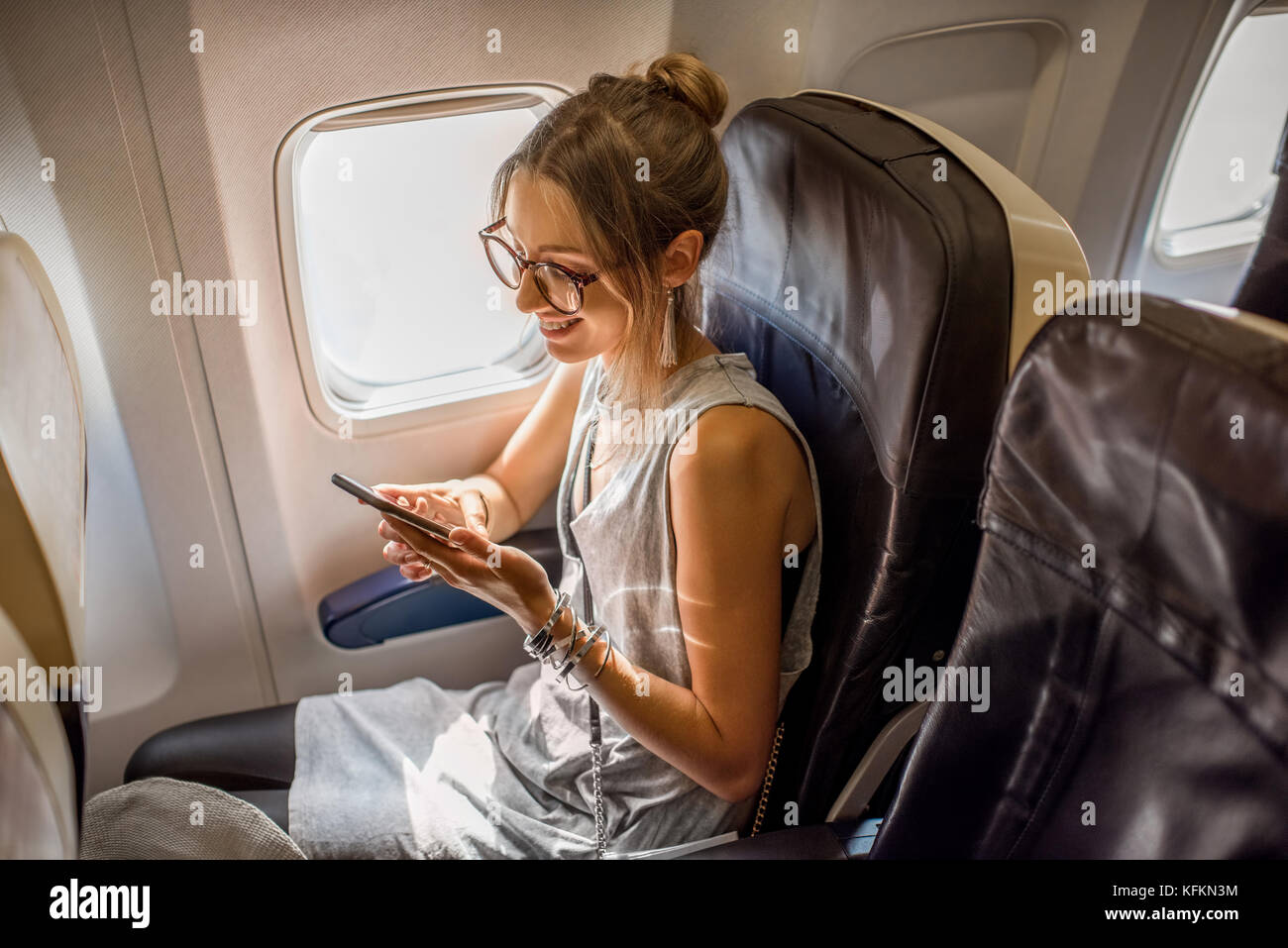 Woman in the airplane Stock Photo