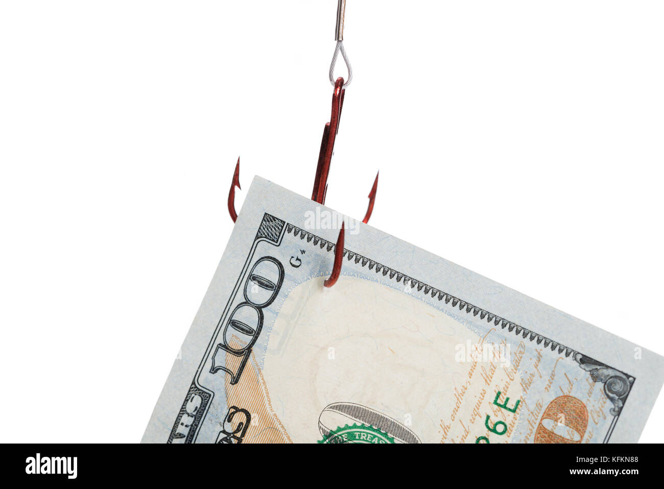 Closeup of hundred dollar bill trapped in fishing hook against white