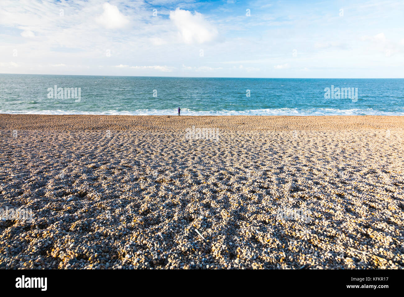 A lone figure on Chesil Beach Stock Photo