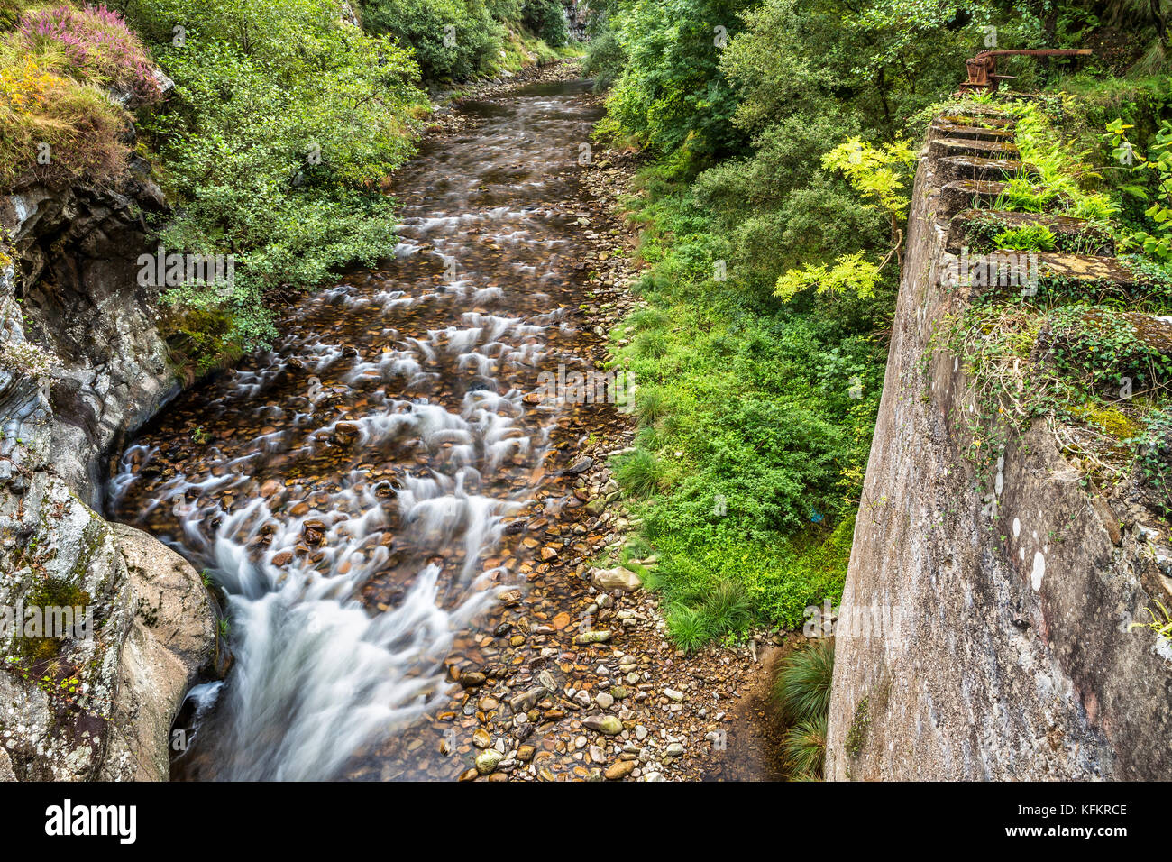 River flowing by an abandoned dam - Asturias, Spain Stock Photo