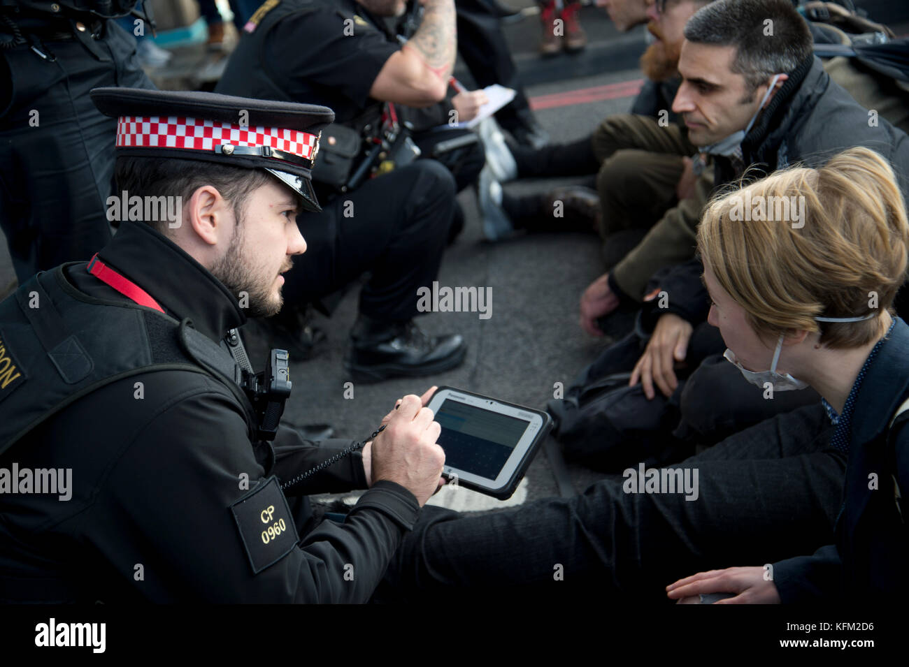 London, UK. 30th Oct, 2017. Action by Stop killing Londoners campaign to draw attention to the poor air quality of London and the effect of this on people's health. For one hour seven activists sat in the road on Tower Bridge, London, stopping traffic. Seven people were arrested. Credit: Jenny Matthews/Alamy Live News Stock Photo
