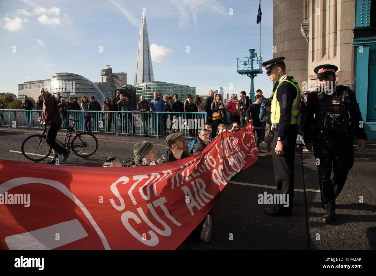 London, UK. 30th October, 2017. Stop Killing Londoners, Cut Air Pollution protest blocks Tower Bridge on 30th October 2017 in central London, England, United Kingdom. Metropolitan police were in attendance talking to the protesters before eventually arresting them all. Stop Killing Londoners: Cut Air Pollution runs a campaign of peaceful civil disobedience, blocking the most polluted streets in the capital until authorities agree to a meeting to seriously consider their proposals. Credit: Michael Kemp/Alamy Live News Stock Photo
