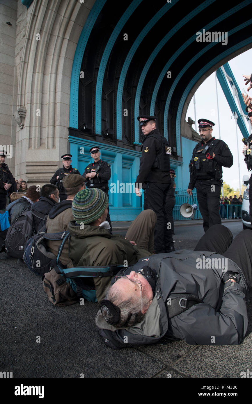 London, UK. 30th October, 2017. Stop Killing Londoners, Cut Air Pollution protest blocks Tower Bridge on 30th October 2017 in central London, England, United Kingdom. Metropolitan police were in attendance talking to the protesters before eventually arresting them all. Stop Killing Londoners: Cut Air Pollution runs a campaign of peaceful civil disobedience, blocking the most polluted streets in the capital until authorities agree to a meeting to seriously consider their proposals. Credit: Michael Kemp/Alamy Live News Stock Photo