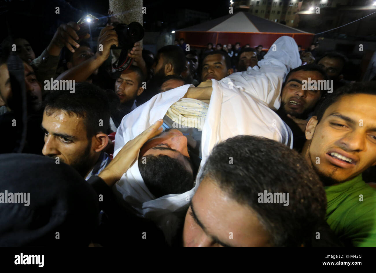 October 30, 2017 - Khan Yunis, Gaza Strip, Palestinian Territory - The body of Palestinian Marwan Alagha, 22, is carried by mourners after he was killed when Israel blew up what it said was a tunnel stretching from the Gaza Strip into its territory, at Naser hospital in Khan Yunis, in the southern Gaza Strip, on October 30, 2017. Ashraf al-Qudra, spokesman for the Hamas-led Gazan health ministry, confirmed six men had been killed. Tunnels dug by Gaza's Islamist rulers Hamas were a key issue in the last war with Israel in 2014, but discoveries of those stretching into the Jewish state have sinc Stock Photo