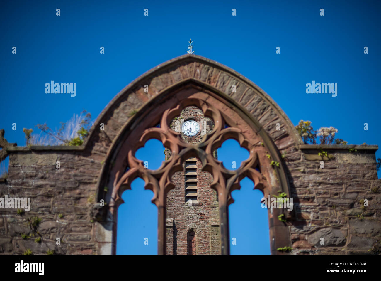 St Peter's Church ruins, Clock tower viewed through the East window, Peel, Isle of Man. Stock Photo