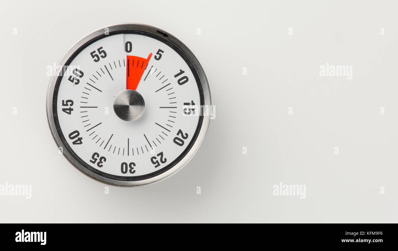 Vintage analog kitchen countdown timer with classical clock face and red remaining time display