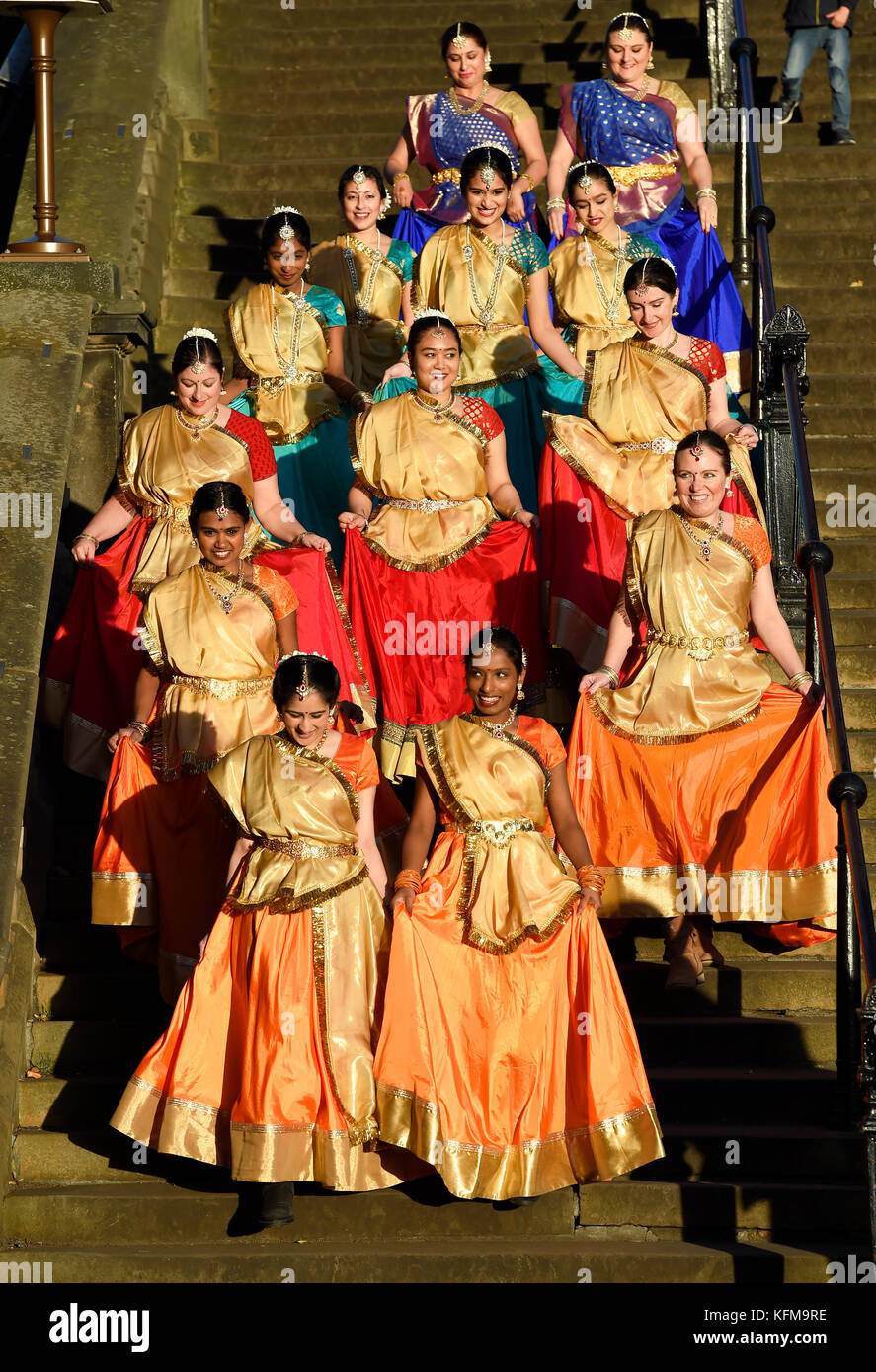 A group of Indian dancers walk down the steps into Princes Street Gardens to perform at the annual Diwali festival in Edinburgh. Stock Photo