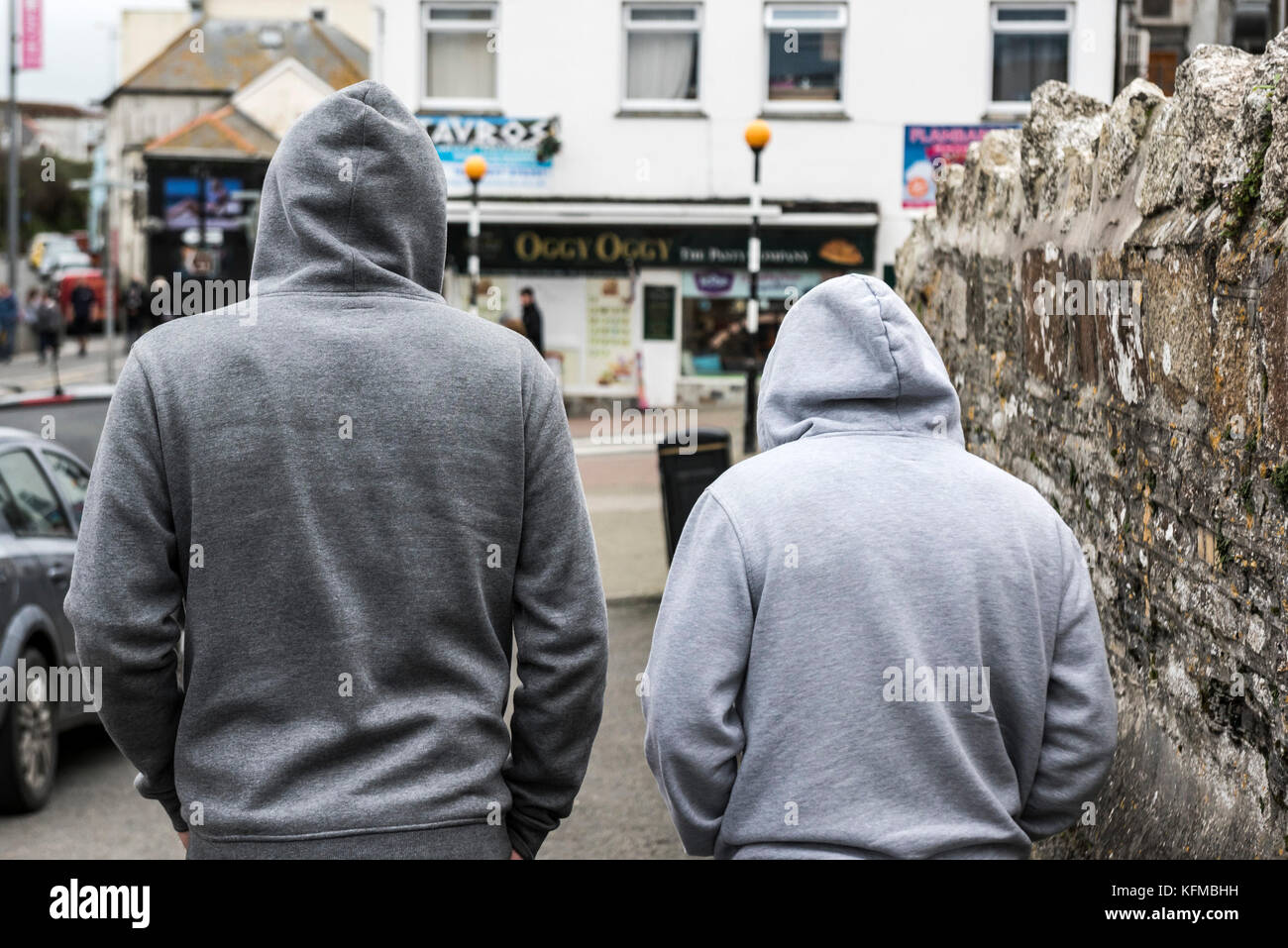 Two men wearing grey hoodies. Stock Photo