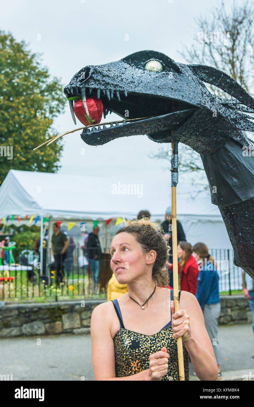 Penryn Kemeneth a two day heritage festival at Penryn Cornwall - a woman holding up a large puppet of a serpent. Stock Photo