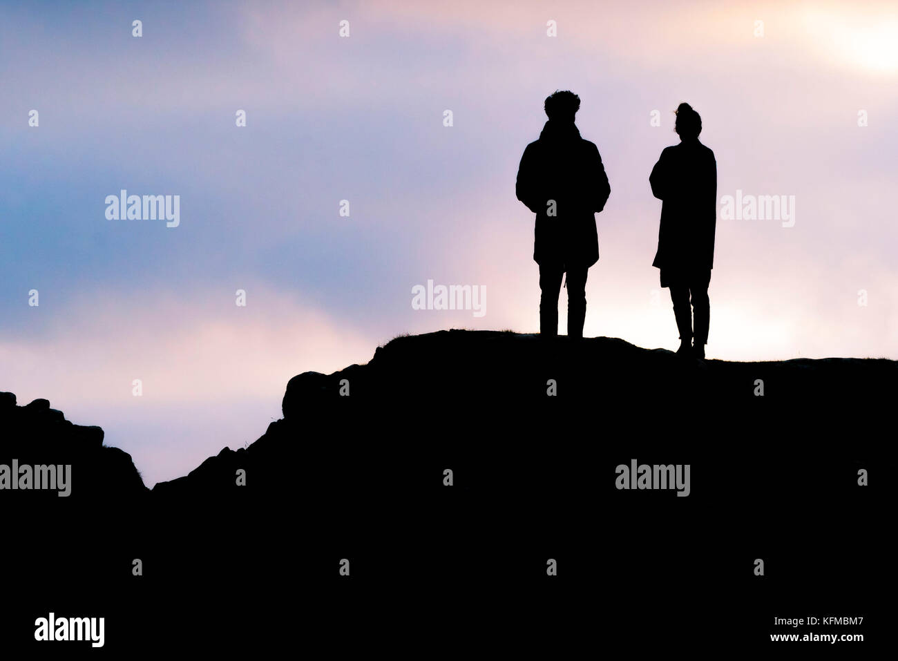 Silhouettes - a couple silhouetted against evening light. Stock Photo