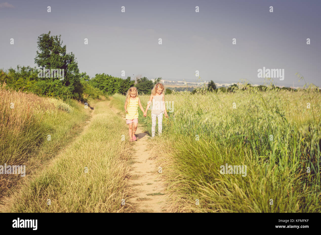 two girls walking together in the country Stock Photo - Alamy