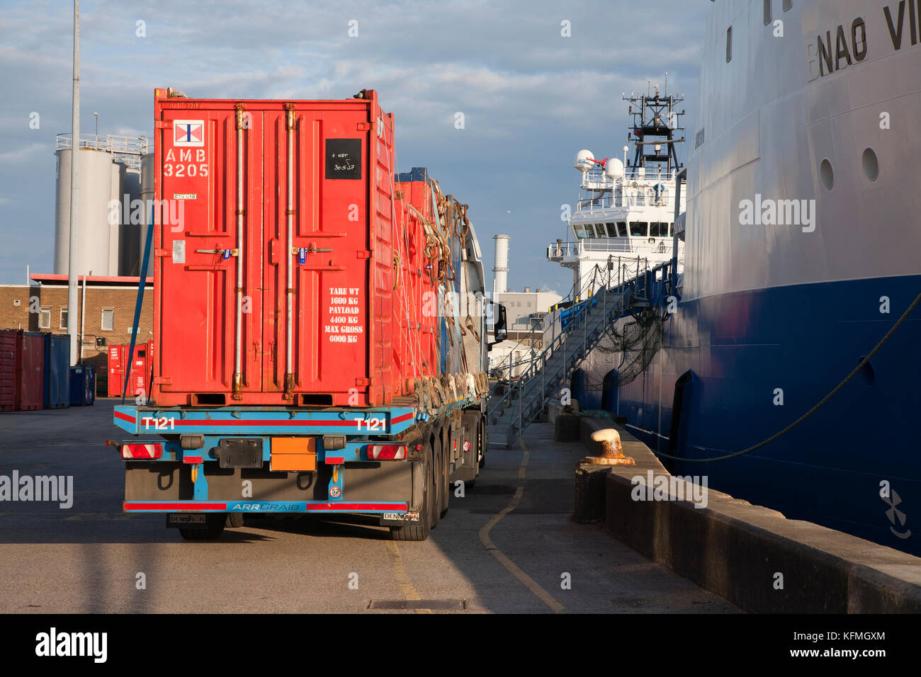 Mini containers wait on a flatbed lorry to be loaded onto offshore supply ship at Asco supply base in Great Yarmouth. Stock Photo