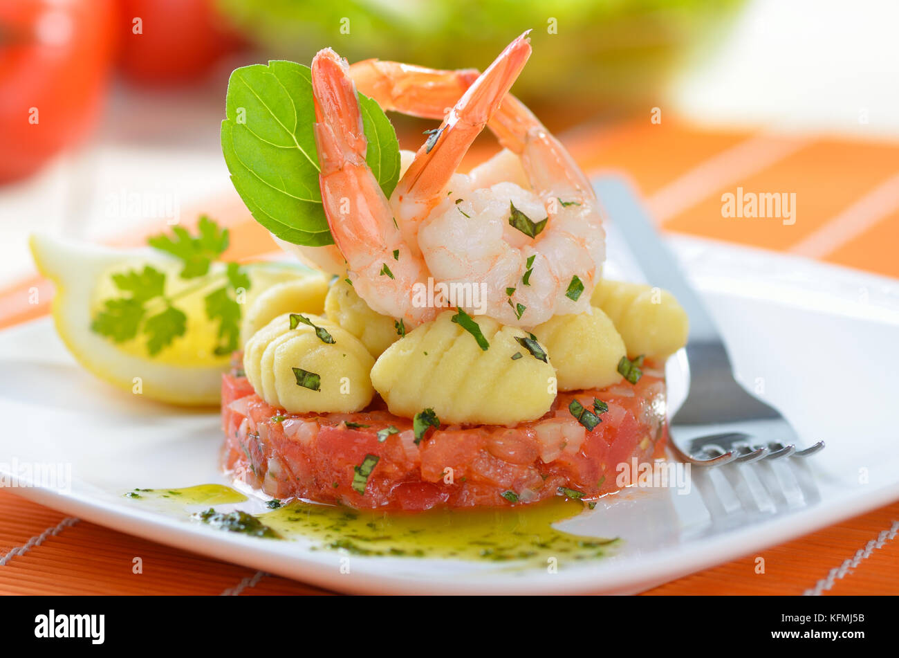 Italian gnocci and tiger prawns on tomato ragout with basil and olive ...