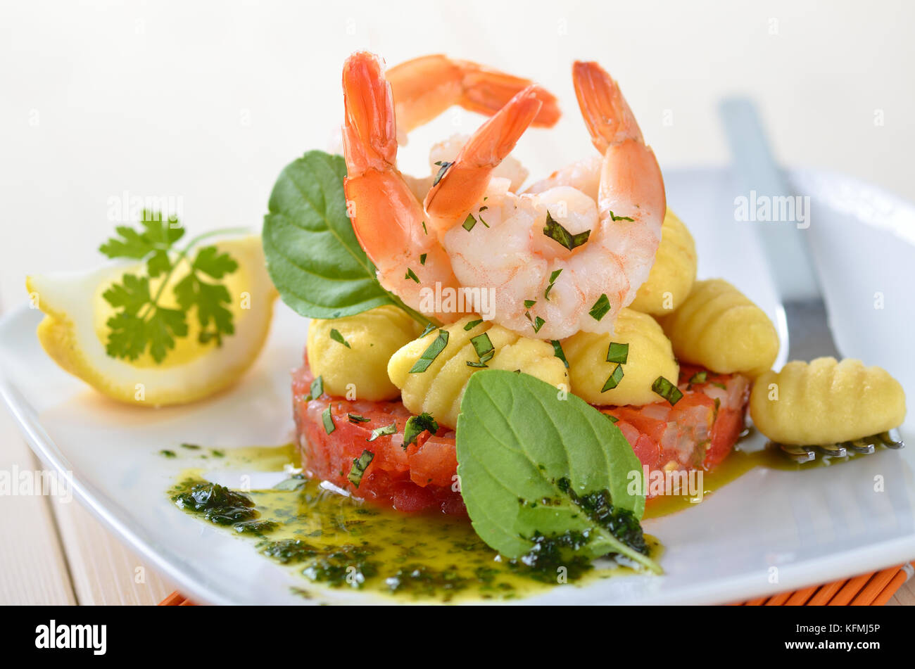 Italian gnocci and tiger prawns on tomato ragout with basil and olive ...