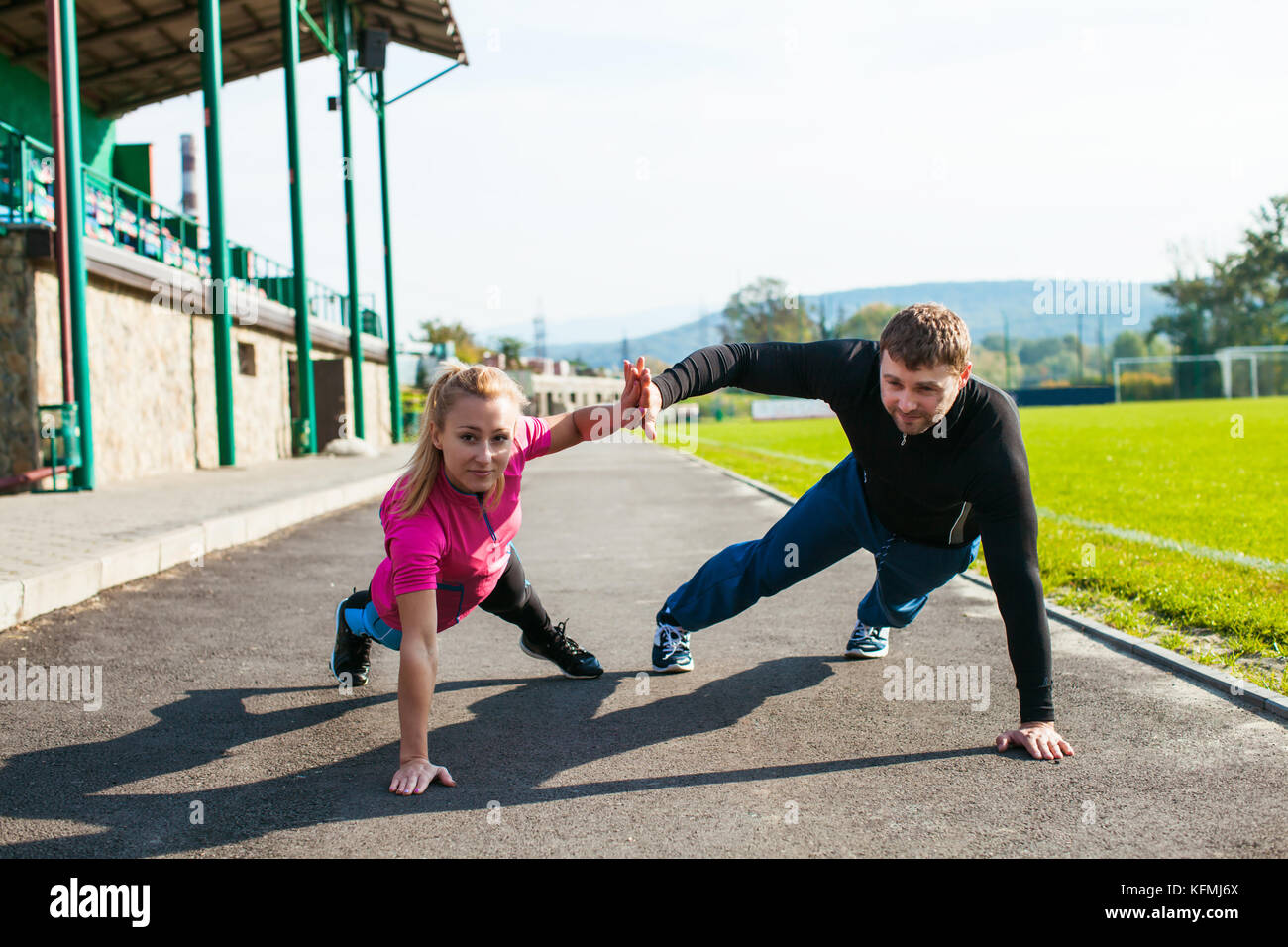Man and woman doing push-up Stock Photo - Alamy