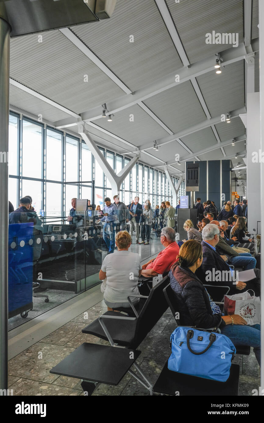 Heathrow Terminal 5, London, UK- September 25, 2017: People queuing and waiting to board a British Airways flight. Typrical gate procedure, vertical s Stock Photo