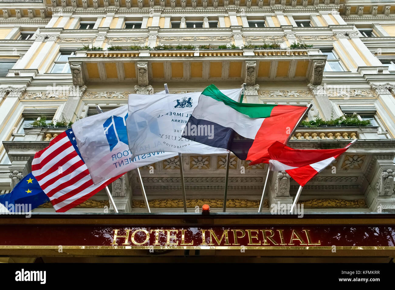 Imperial hotel building facade with flags. 5 star luxury hotel. Sign. Exterior Wurttemberg Palace. Vienna City, Austria, Europe. Lifestyle concept. Stock Photo