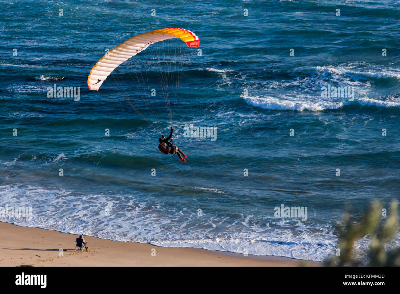 A man paragliding at portsea over the beach in victoria Stock Photo