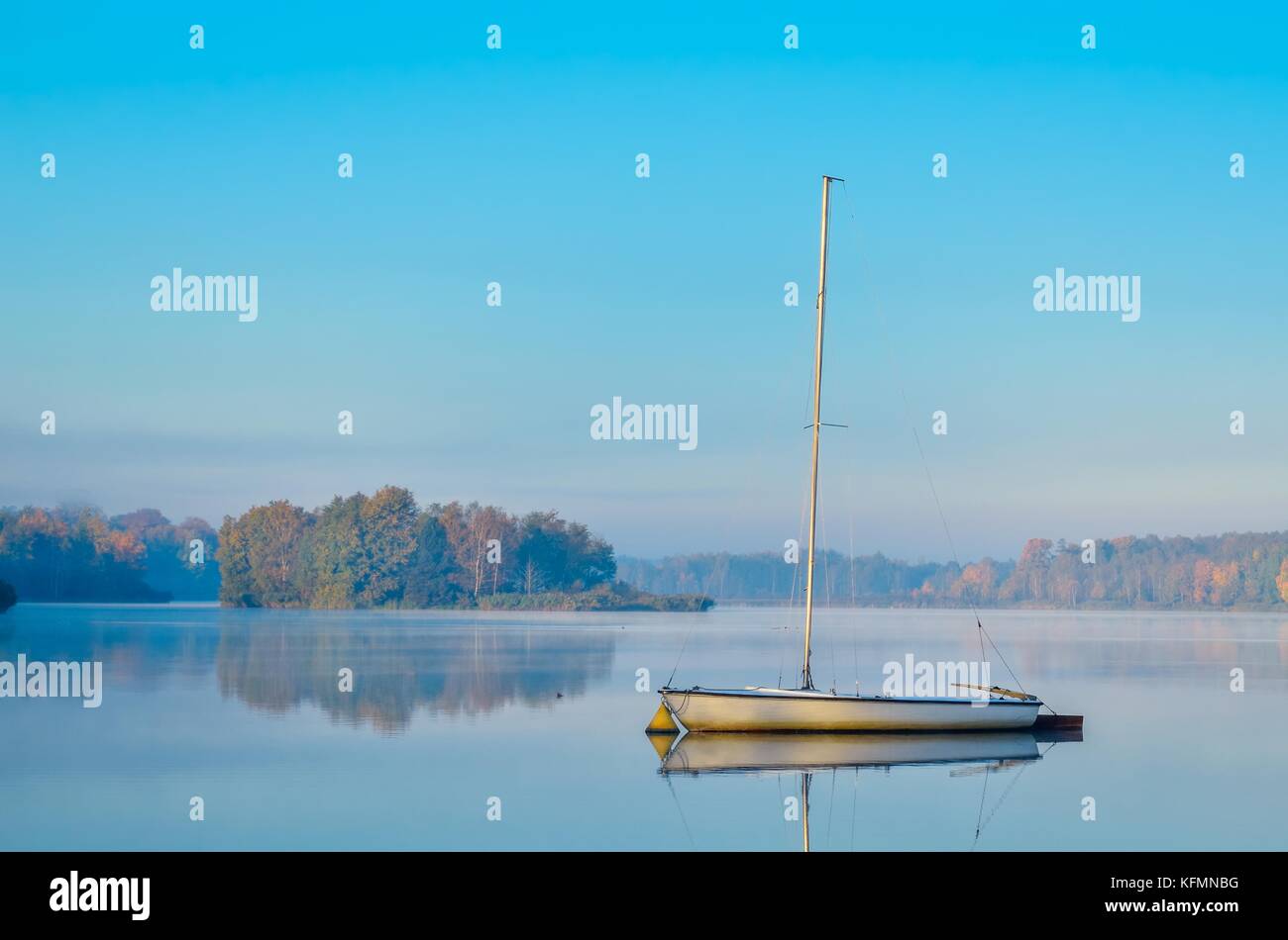 Morning autumn landscape. Boat on a beautiful lake Stock Photo - Alamy