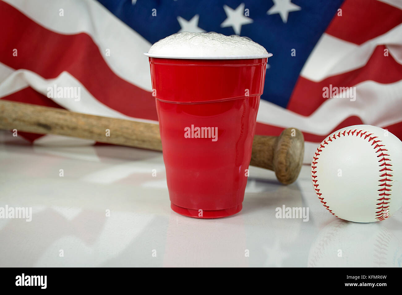 beer in red cup with baseball and wooden bat with American flag