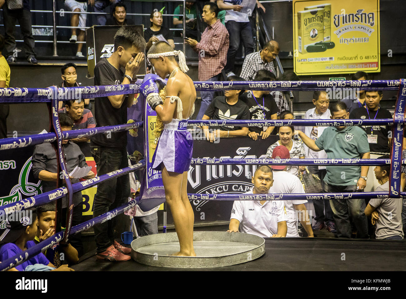 Coach and boy muay Thai fighter through pre-fight ritual, Thailand Stock Photo
