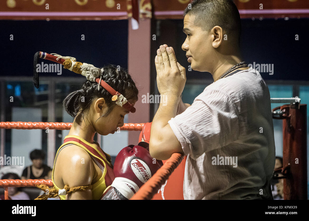 Coach and Sarania 11 year old, muay Thai fighter and coach through pre-fight ritual, Thailand Stock Photo