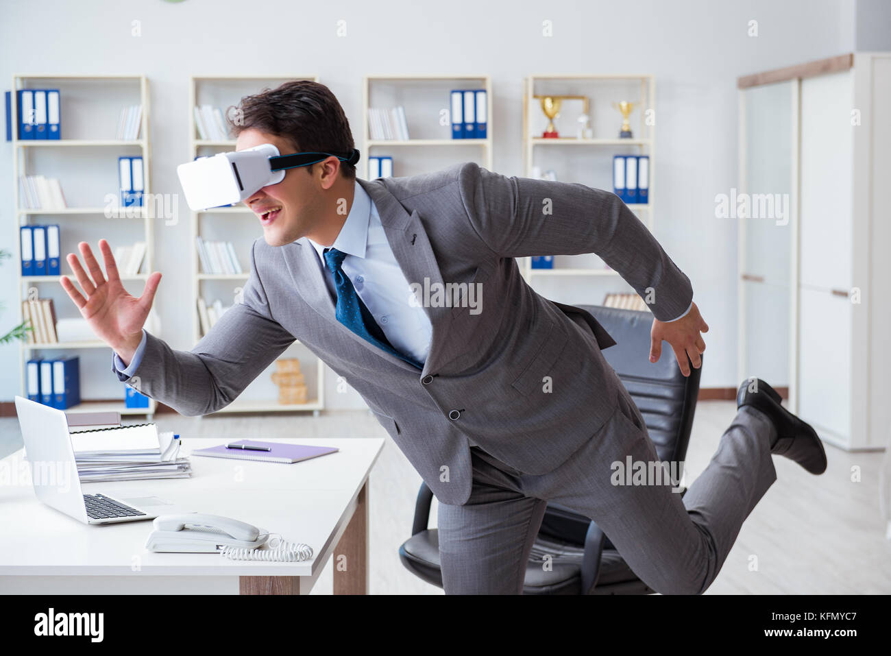 Businessman exercising in office wearing VR glasses Stock Photo - Alamy