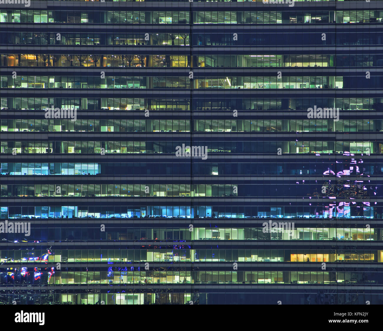 late-night-at-office-multi-stories-office-building-at-night-with-worker-working-overtime
