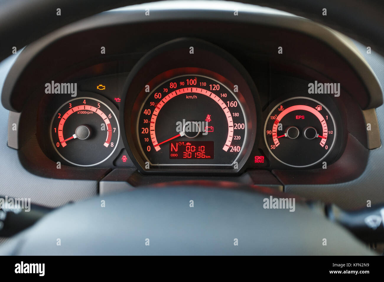 Car dashboard with red light, close up Stock Photo