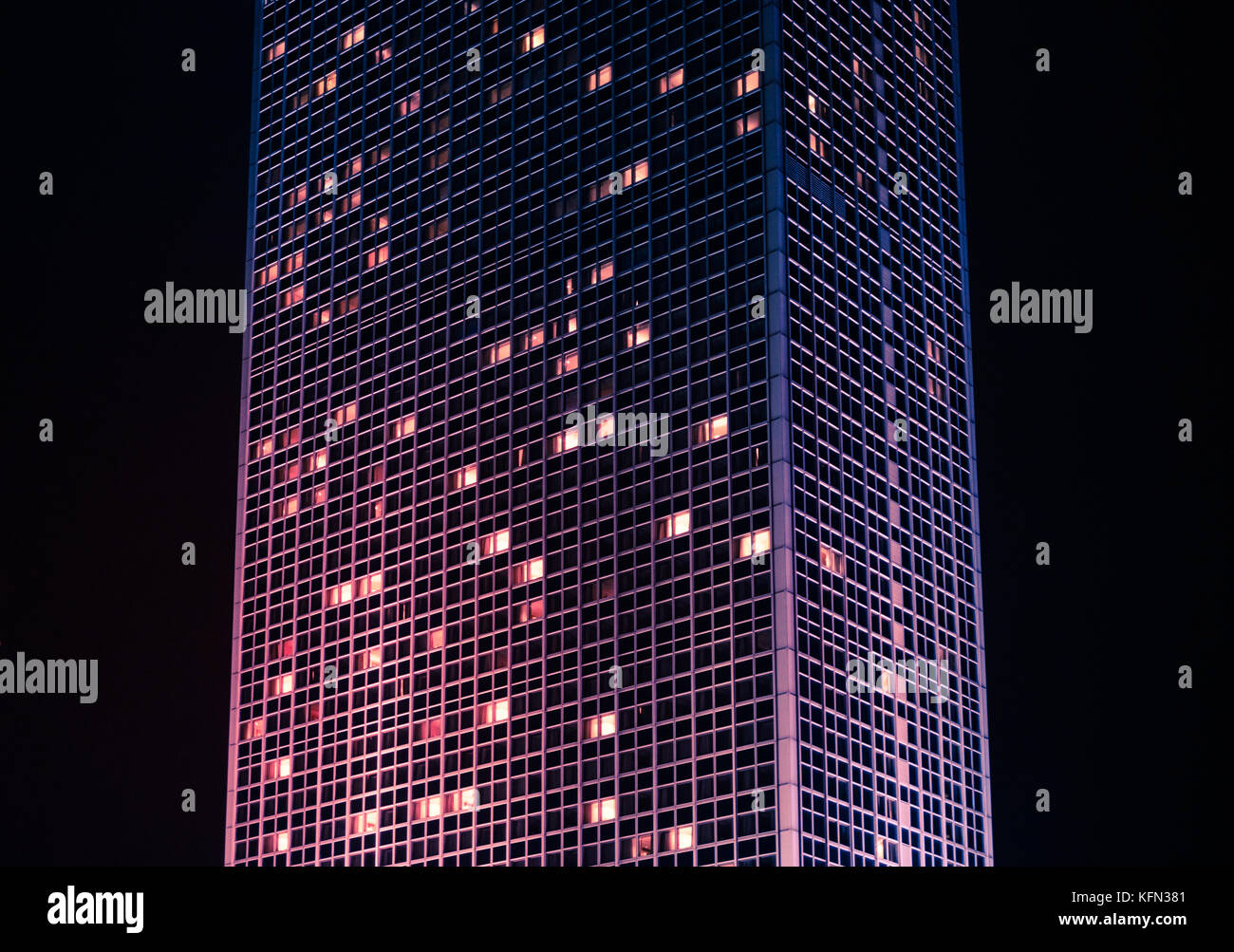 tall skyscraper building at night - modern building exterior Stock Photo