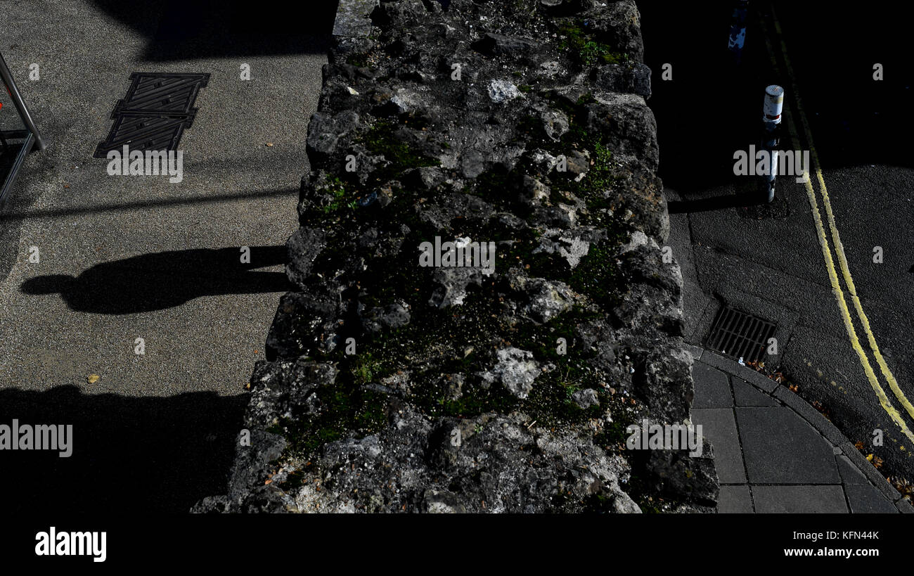 A single male shadow falls on the ground giving a sense of doom or scary unease. Stock Photo