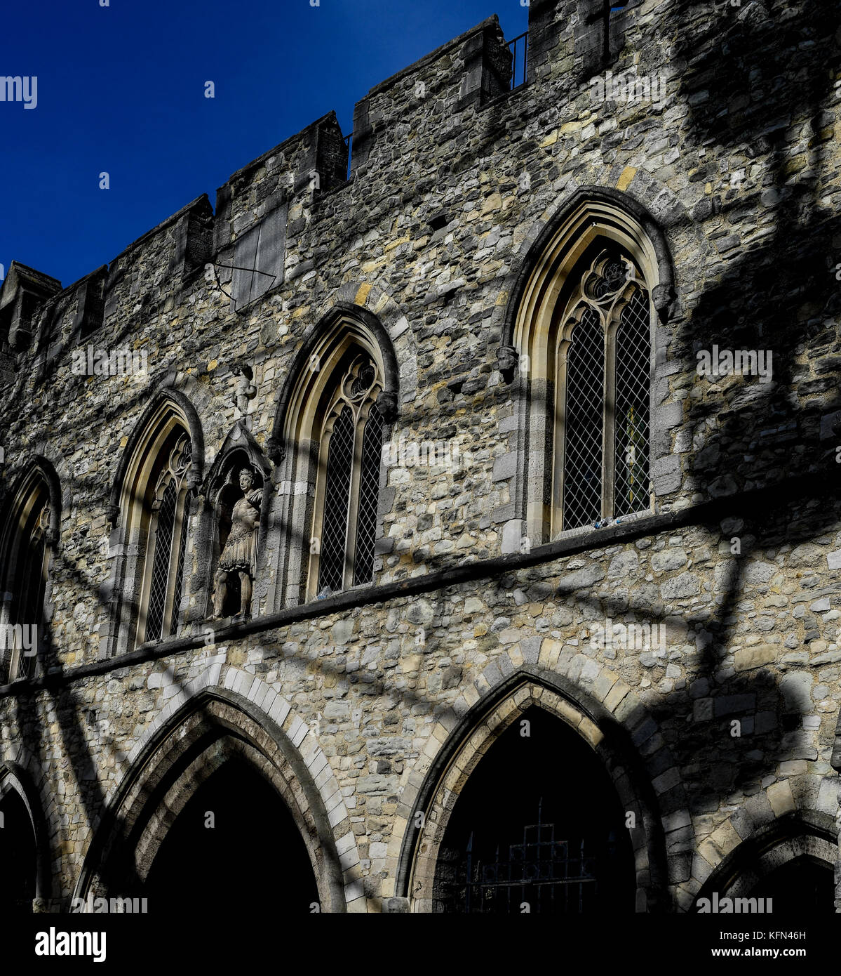 The Bargate in Southampton with the shadows of a near by ferris wheel across the stone work.The Bargate is a medieval gate house once entrance to city Stock Photo