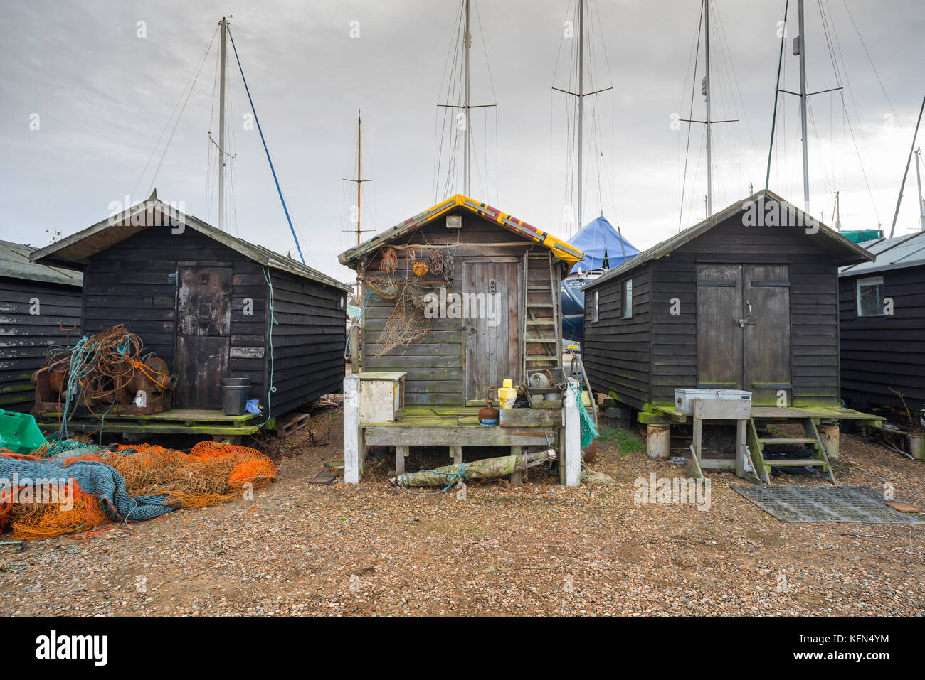 Suffolk coast, view of a row of three old fishing huts at Felixstowe