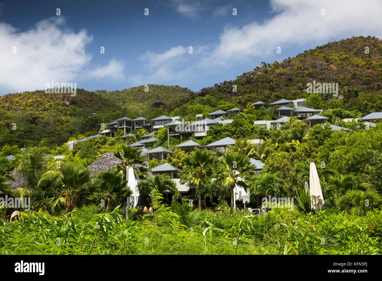 The Seychelles, Praslin, Anse Takamaka, Raffles Praslin Hotel and Resort, rooms on lush hillside Stock Photo