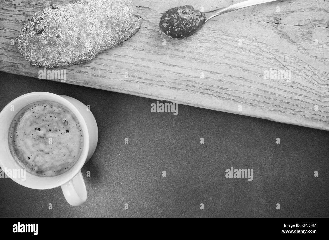 home made pastry and cookies with fig jam and hot coffee - top view dark stone and wood surface Stock Photo