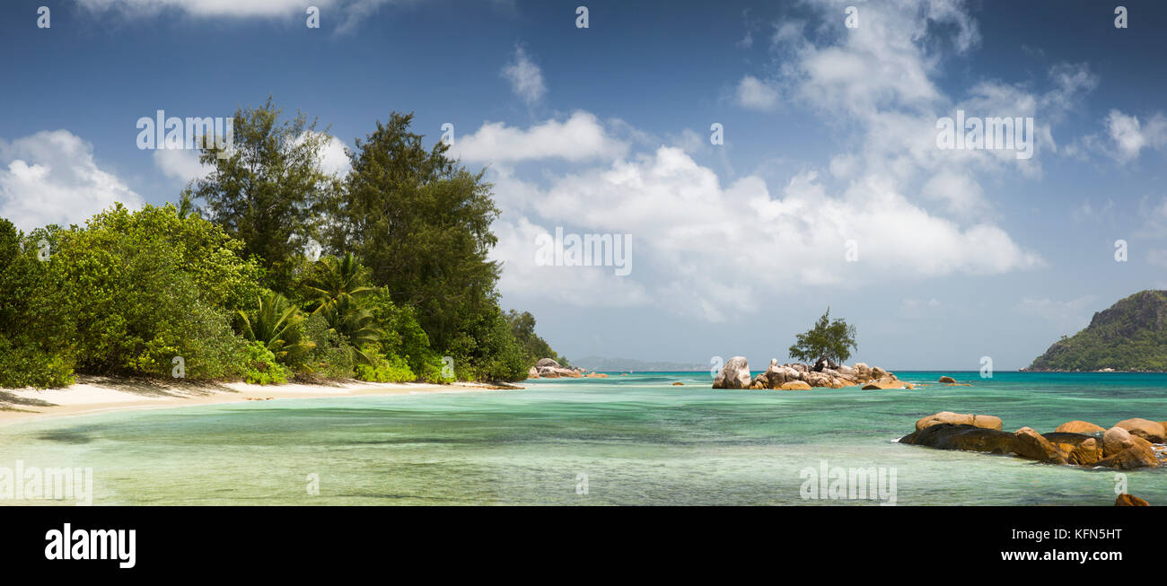 The Seychelles, Praslin, Anse Takamaka, secluded empty white sand beach with sheltered lagoon, panorama Stock Photo