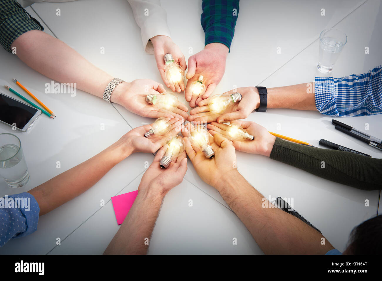 Teamwork and brainstorming concept with businessmen that share an idea with a lamp. Concept of startup Stock Photo