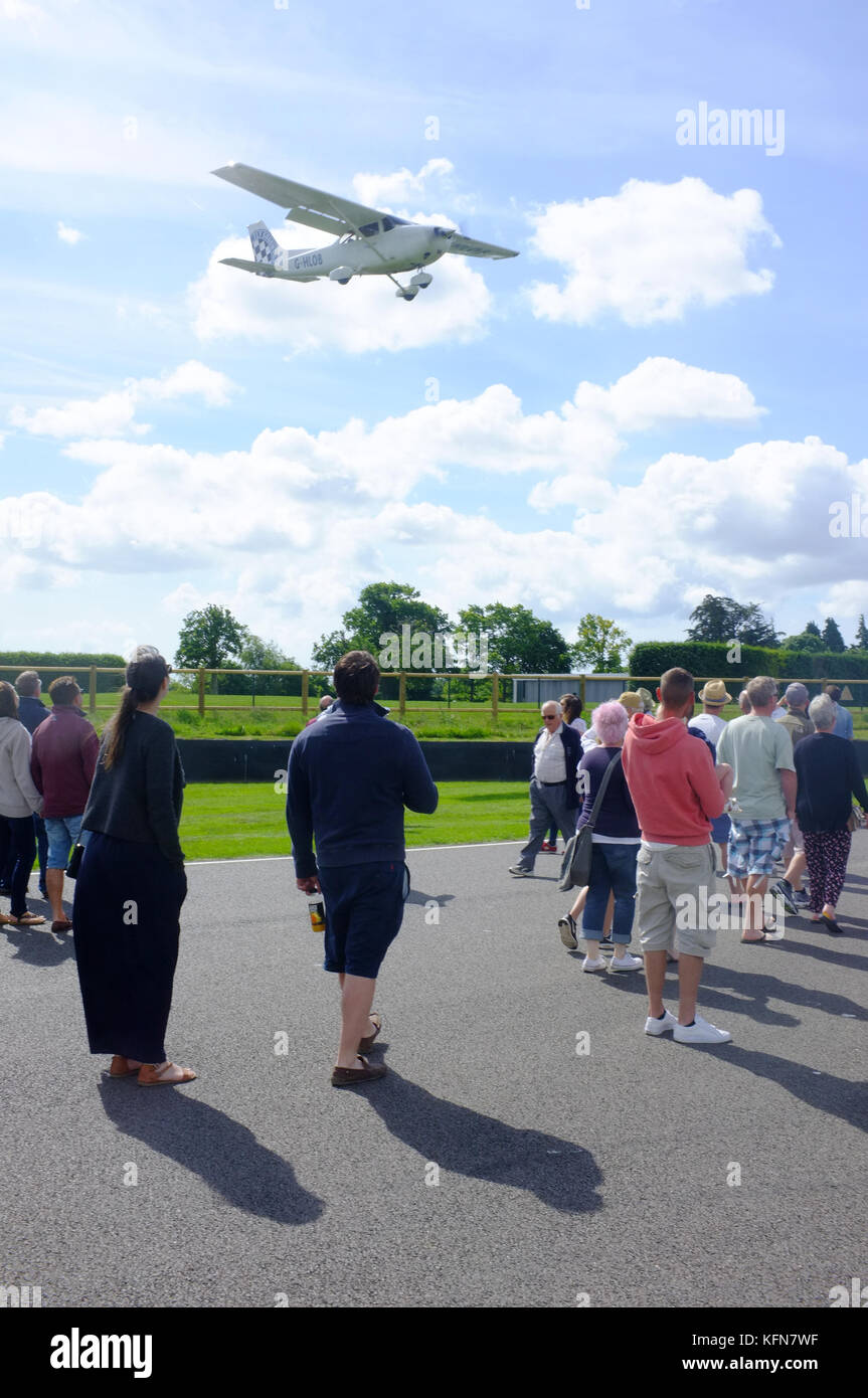 A low flying plane at the Goodwood racing circuit in West Sussex Stock Photo