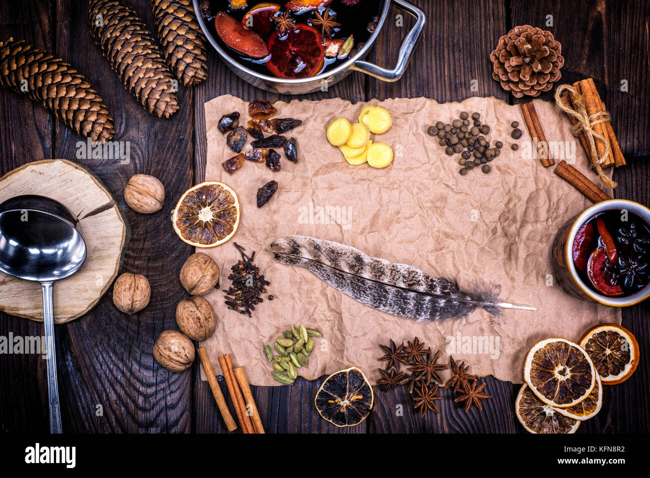crumpled brown sheet of paper with a feather and ingredients for making a mulled wine drink, top view Stock Photo