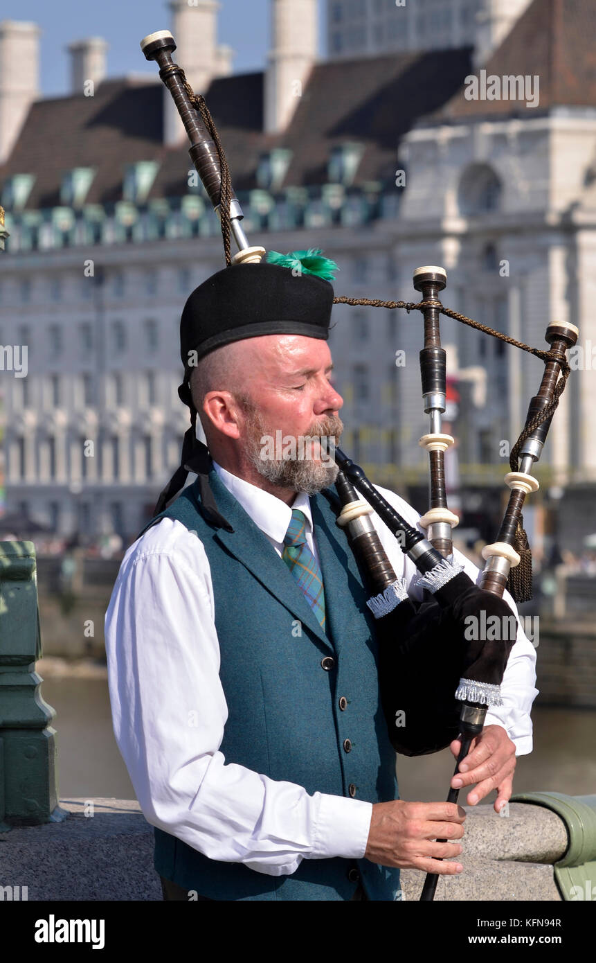 Highland bagpiper, Westminster Bridge, London, UK. Stock Photo