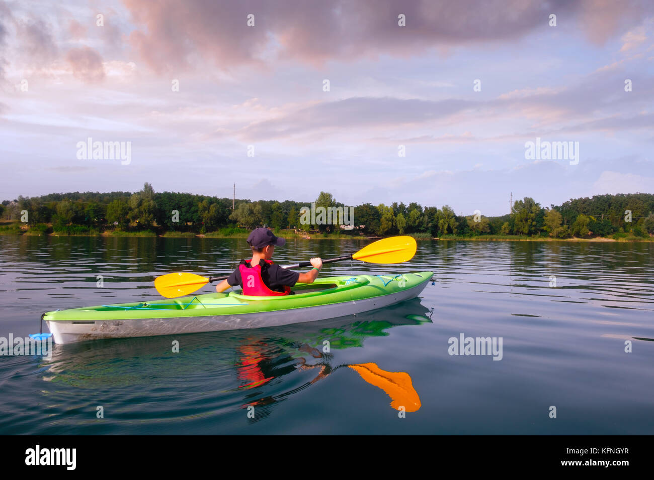 Boy in life jacket on green kayak Stock Photo Alamy