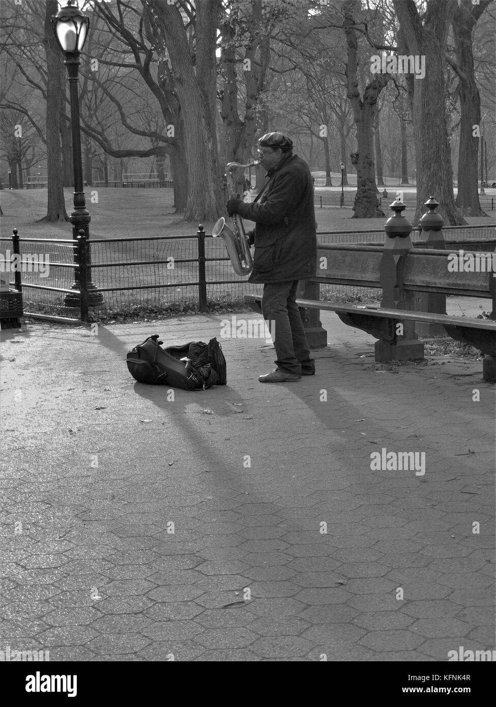 Sax player playing in Central park in Manhattan on a December day Stock