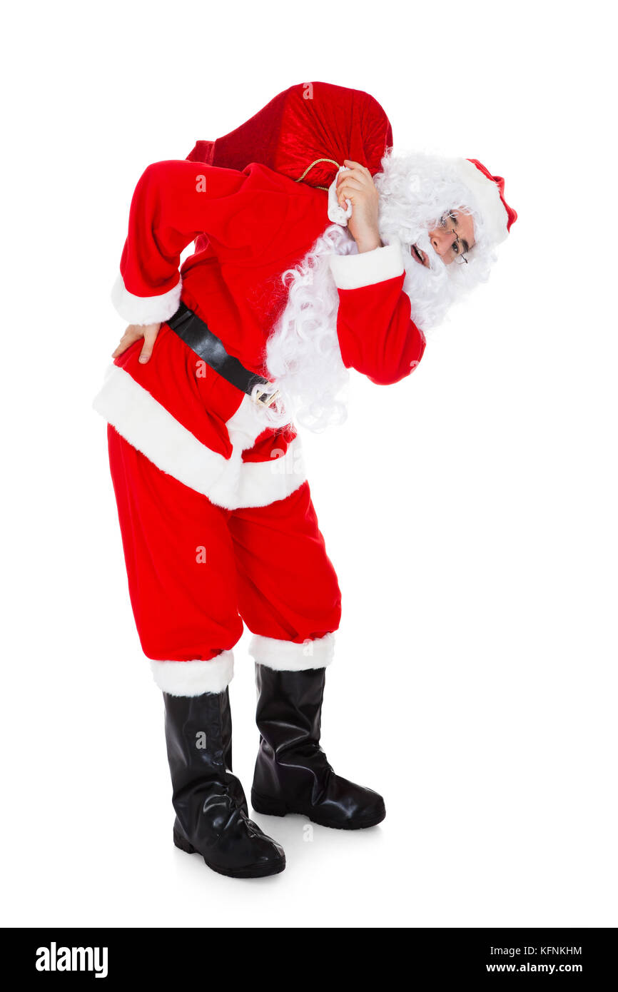Portrait of santa carrying sack over white background Stock Photo - Alamy