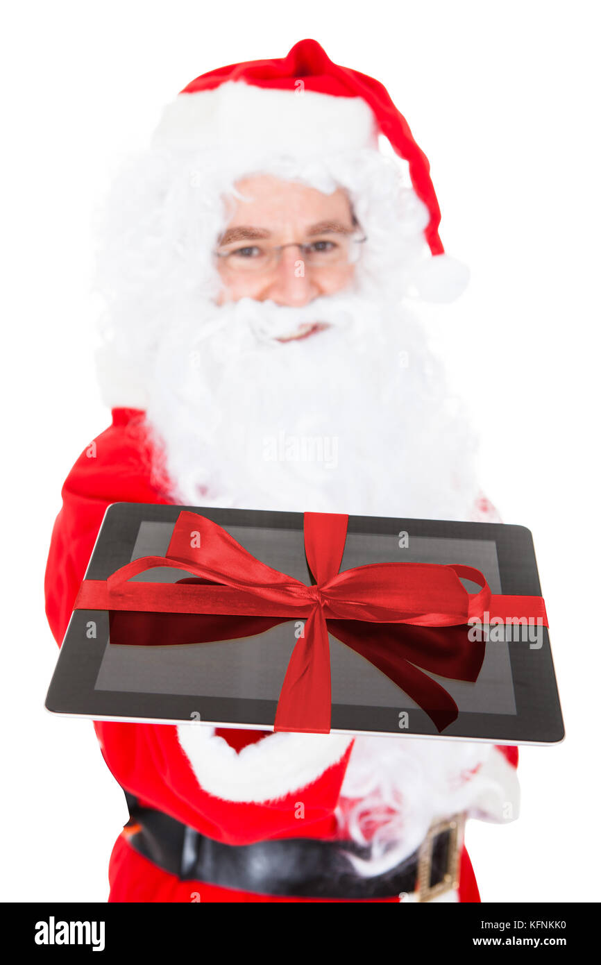 Santa holding digital tablet on white background Stock Photo - Alamy