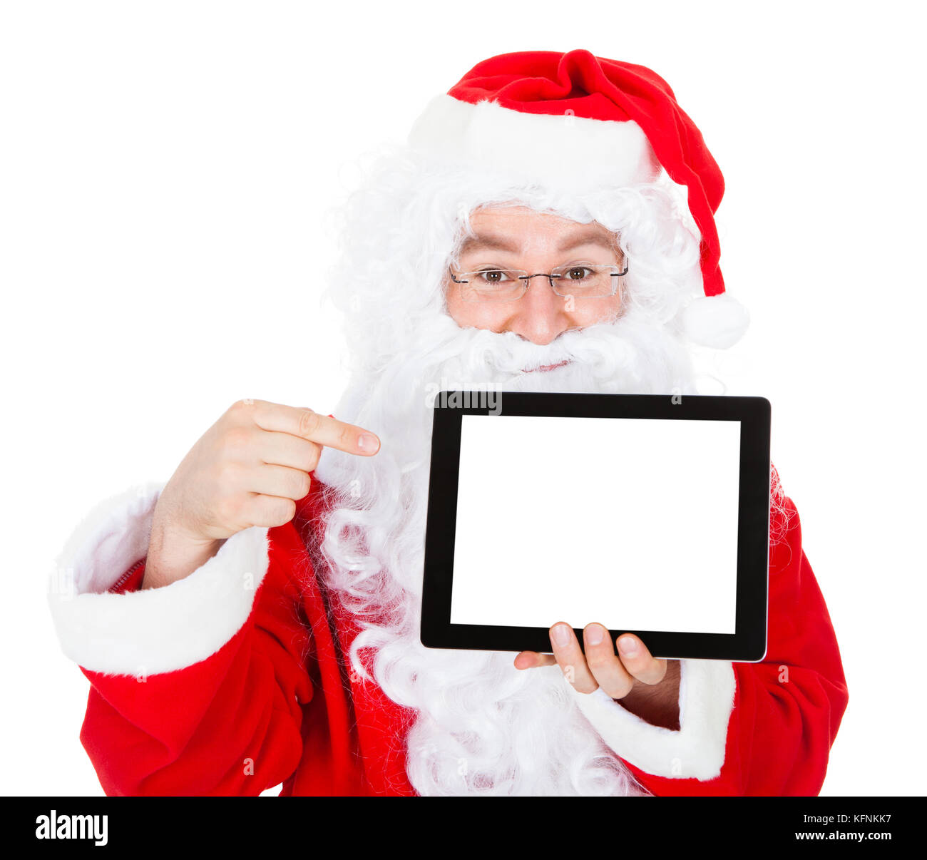 Portrait of santa pointing at digital tablet over white background ...