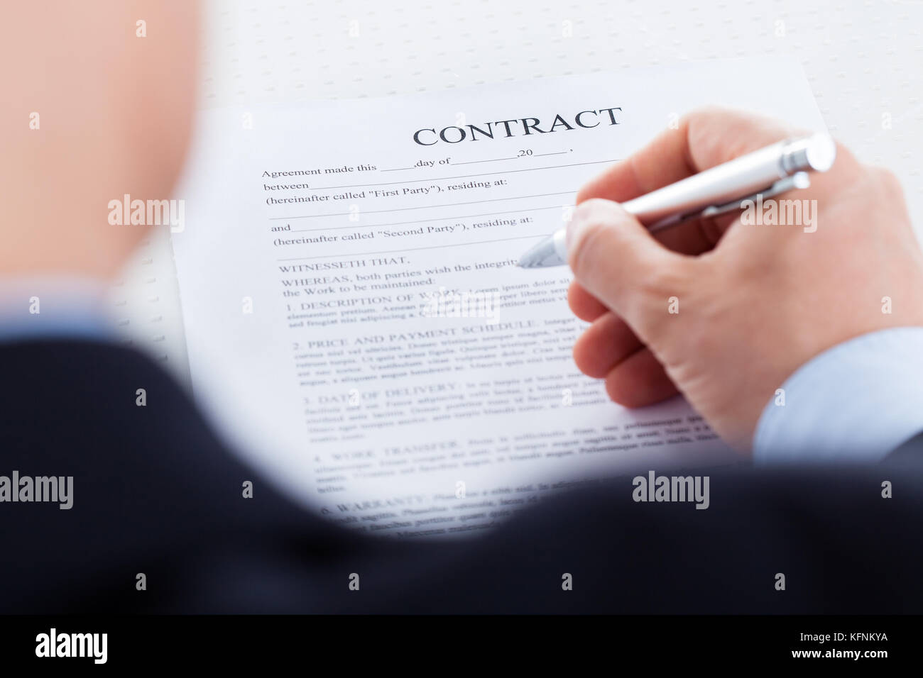 Close-up Of Businessman Hand Holding Pen Over Contract Form Stock Photo ...