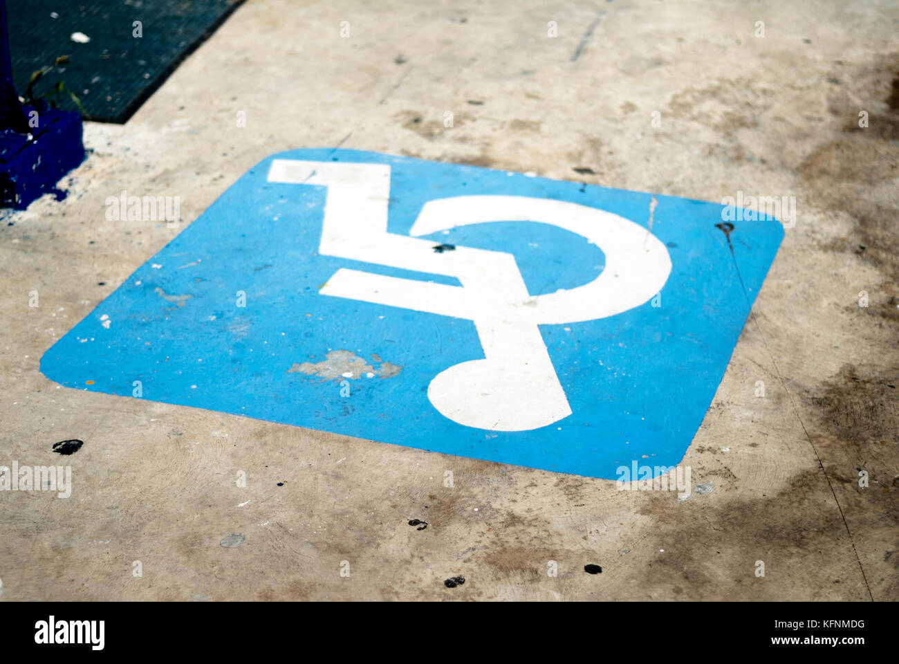 Empty parking space shows ISA symbol for wheelchair users and people with disabilities Stock Photo